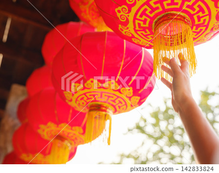 Woman Hand Reaching Hanging Red Chinese Lantern Close Up Woman Hand Reaching Hanging Red Chinese Lantern Close Up 142833824