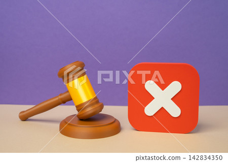 A rejection symbol and a judge's gavel. Concept of legal denial and court ruling. Symbol of failed appeals, disputes and regulatory refusal in court today. Legal accountability. 142834350