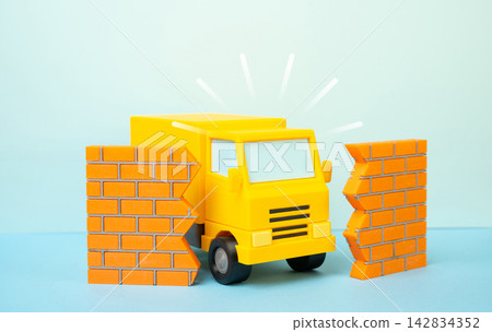 A delivery truck breaking through a wall, concept. Symbol of overcoming logistics obstacles and fast delivery. Concept of breakthrough shipping speed today. Fast progress. A delivery truck breaking through a wall, concept. Symbol of overcoming logistics obstacles and fast delivery. Concept of breakthrough shipping speed today. Fast progress. 142834352