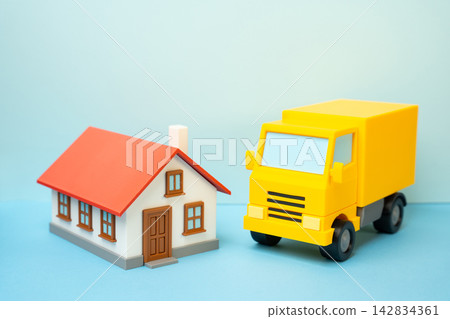 A delivery truck and a residential house. Package delivery. A moving company relocating to another home. Concept of logistics and household relocation service. New beginnings. A delivery truck and a residential house. Package delivery. A moving company relocating to another home. Concept of logistics and household relocation service. New beginnings. 142834361