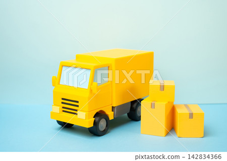 A delivery truck and boxes of goods. Order delivery. Concept of e-commerce logistics and fast shipping. Online retail and courier services today. Quick fulfillment. A delivery truck and boxes of goods. Order delivery. Concept of e-commerce logistics and fast shipping. Online retail and courier services today. Quick fulfillment. 142834366