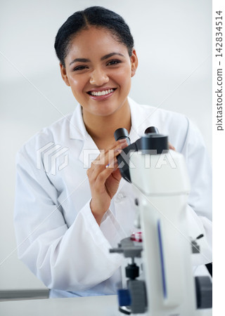 Portrait, science and happy woman on microscope in lab for research, exam or analysis in Brazil. Scientist, face and professional on medical equipment for chemistry, biotechnology or microbiology 142834514