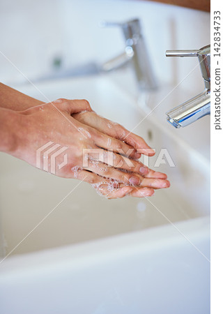 Woman, hands and soap for washing in bathroom with water, cleaning for hygiene or safety from virus. Female person, palms and together for health in home with foam, skincare for wellness or bacteria Woman, hands and soap for washing in bathroom with water, cleaning for hygiene or safety from virus. Female person, palms and together for health in home with foam, skincare for wellness or bacteria 142834733