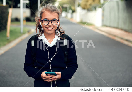 Portrait, outdoor walking and child with earphones for music, streaming kpop playlist, radio and commute for school. Student girl, walk and listening to audio with podcast for education and knowledge Portrait, outdoor walking and child with earphones for music, streaming kpop playlist, radio and commute for school. Student girl, walk and listening to audio with podcast for education and knowledge 142834758