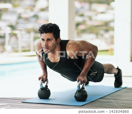 Push up, kettlebell or man in fitness training, exercise or workout for wellness, routine or balance. Ready, abs challenge or serious athlete with strong arms for muscles, activity or body mobility Push up, kettlebell or man in fitness training, exercise or workout for wellness, routine or balance. Ready, abs challenge or serious athlete with strong arms for muscles, activity or body mobility 142834860