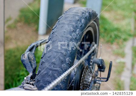 Damaged electric bicycle wheel with bald rubber tread Damaged electric bicycle wheel with bald rubber tread 142835129