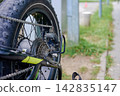 Worn out fatbike tire and rear derailleur detail 142835147