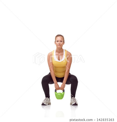 Fitness, portrait and woman exercise with kettlebell swing, squat or workout for muscle growth, arm strength or bodybuilding. Studio, weightlifting hard work and athlete training on white background 142835163