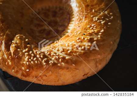 Traditional Uzbek non bread with sesame seeds close-up Traditional Uzbek non bread with sesame seeds close-up 142835184