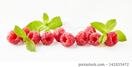 Raspberries and mint leaves on white background Raspberries and mint leaves on white background 142835472