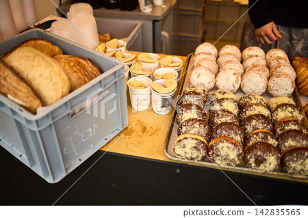 Assorted Fresh Pastries Display - Croissants, Donuts, and Baked Goods at Market Assorted Fresh Pastries Display - Croissants, Donuts, and Baked Goods at Market 142835565