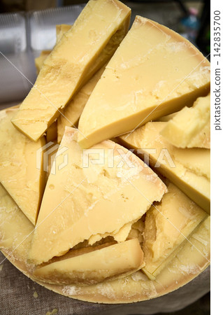 Assorted Artisan Cheeses Display in Wicker Baskets at Market 142835700