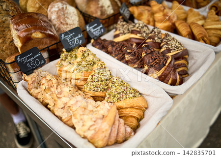 Fresh Croissants and Assorted Pastries Display at Bakery Market Fresh Croissants and Assorted Pastries Display at Bakery Market 142835701