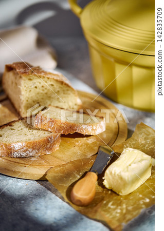 Sliced rustic sourdough bread showing airy crumb texture on wooden board Sliced rustic sourdough bread showing airy crumb texture on wooden board 142835709