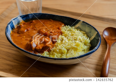 Authentic chicken curry and saffron rice served in a deep dish. Authentic chicken curry and saffron rice served in a deep dish. 142835762