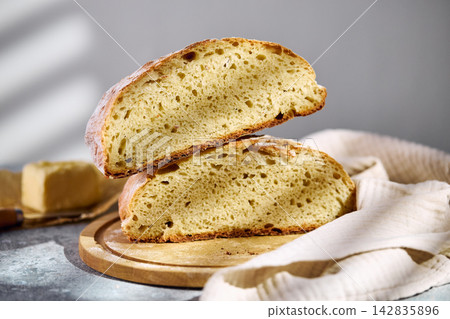 Sliced rustic sourdough bread showing airy crumb texture on wooden board Sliced rustic sourdough bread showing airy crumb texture on wooden board 142835896