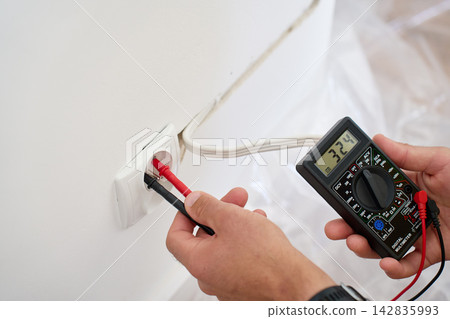Testing wall outlet voltage with digital multimeter Testing wall outlet voltage with digital multimeter 142835993