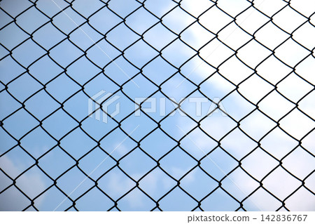 Chain Link Fence against Blue Sky Background 142836767