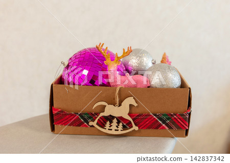 Decorative box with colorful ornaments and a small deer figurine for Christmas season decoration Decorative box with colorful ornaments and a small deer figurine for Christmas season decoration 142837342