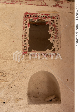 Window frame with decorative design at an old building located in a historical area during the daytime 142837388