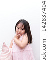 A 5-year-old girl wearing a nightgown 142837404