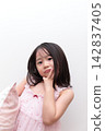 A 5-year-old girl wearing a nightgown 142837405