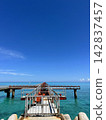 A pier with guide lights stretching out into the blue sea at Shimojishima 17END 142837457