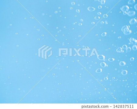 Bubbles rising in the water, against a blue abstract background. Bubbles rising in the water, against a blue abstract background. 142837511
