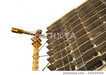 A multi-story building under construction with a tower crane isolated on transparent background, looking up. Residential construction, real estate investment at the construction stage 142839309
