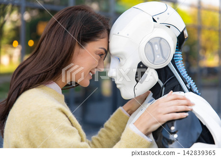 Happy woman leaning forehead against humanoid android Happy woman leaning forehead against humanoid android 142839365