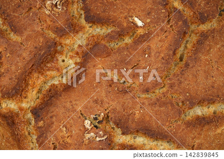 Freshly baked rustic bread crust in a close up full frame background Freshly baked rustic bread crust in a close up full frame background 142839845