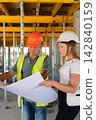 Workers determine material quantities needed for construction 142840159