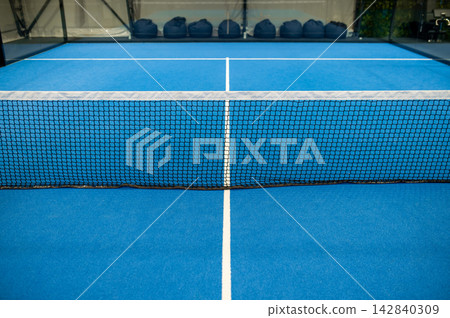 Picture of a paddle tennis court interior with no one there 142840309