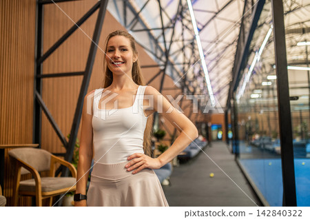 Long-haired blonde woman in tennis skirt ate the paddle tennis courts Long-haired blonde woman in tennis skirt ate the paddle tennis courts 142840322