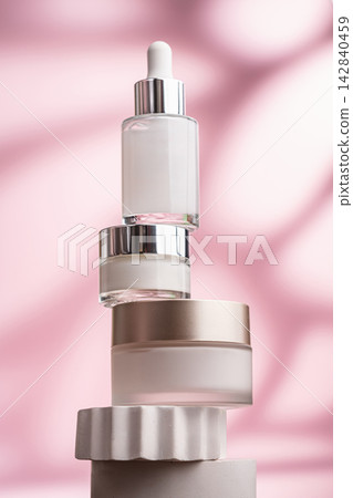Anti-aging skincare set with serum and creams on pink background Anti-aging skincare set with serum and creams on pink background 142840459