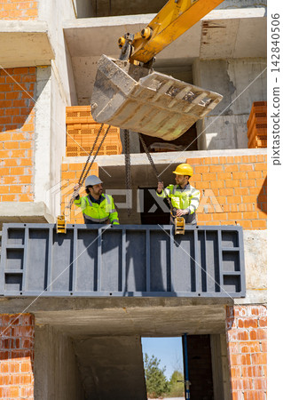 Construction workers installing heavy steel formwork panel Construction workers installing heavy steel formwork panel 142840506