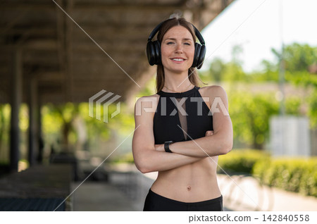 Pretty confident young caucasian woman in headphones Pretty confident young caucasian woman in headphones 142840558