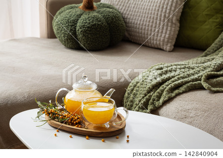 Comforting Autumn Evening Scene With Sea Buckthorn Tea And Cozy Decor Elements Comforting Autumn Evening Scene With Sea Buckthorn Tea And Cozy Decor Elements 142840904