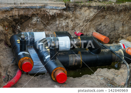 Pre-Insulated District Heating Pipes and Fittings Installed in Excavated Underground Utility Trench 142840969