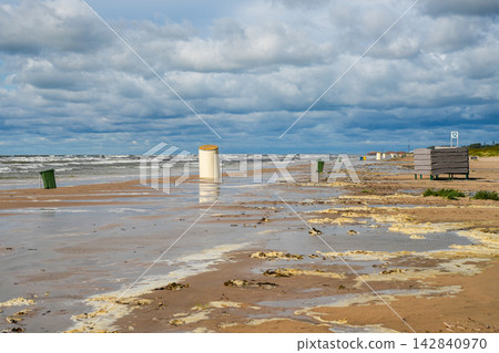 Stormy Baltic Sea Beach with Sea Foam, Rough Waves and Dramatic Clouds Along Sandy Coastline Stormy Baltic Sea Beach with Sea Foam, Rough Waves and Dramatic Clouds Along Sandy Coastline 142840970