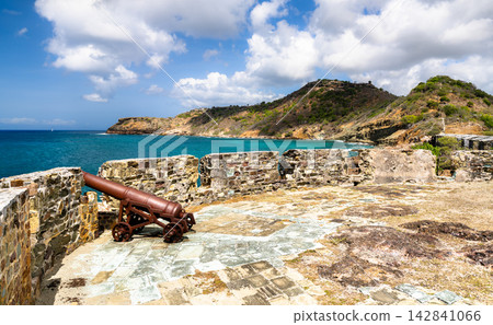 Rusty historic cannon mounted on stone fortification wall at Fort Berkeley in Nelson's Dockyard National Park, Antigua and Barbuda. Rusty historic cannon mounted on stone fortification wall at Fort Berkeley in Nelson's Dockyard National Park, Antigua and Barbuda. 142841066