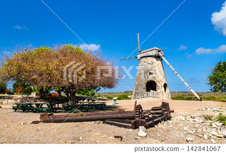 A restored stone windmill and old sugar mill machinery at Betty's Hope Historic Sugar Plantation on the island of Antigua. A restored stone windmill and old sugar mill machinery at Betty's Hope Historic Sugar Plantation on the island of Antigua. 142841067