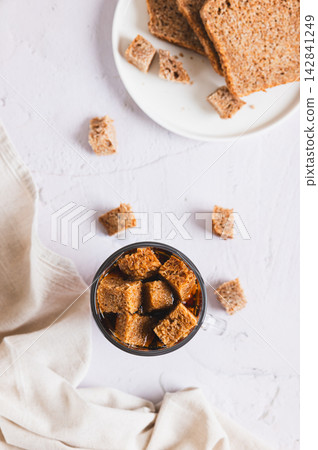 Traditional fermented rye bread kvass in a glass on the table top and vertical view Traditional fermented rye bread kvass in a glass on the table top and vertical view 142841249
