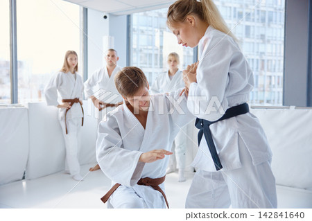 Female student practicing aikido with instructor Female student practicing aikido with instructor 142841640