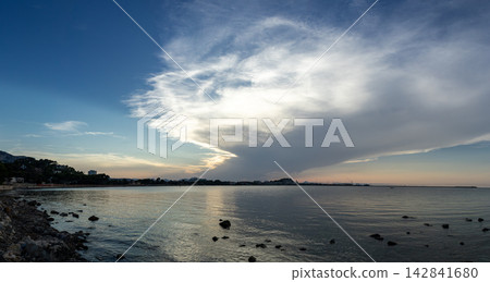 Wide panoramic view of Mediterranean coastline and Denia port under sunset sky 142841680