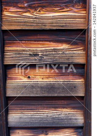 The texture of the burnt cedar plank walls, with their deep wood grain, is beautiful and can be seen in traditional Japanese wooden architecture. The texture of the burnt cedar plank walls, with their deep wood grain, is beautiful and can be seen in traditional Japanese wooden architecture. 142841937