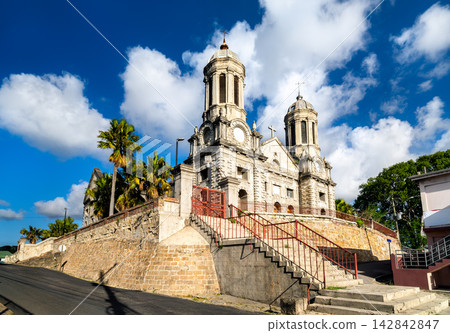 Facade of Saint John's Cathedral against a bright sky with white clouds in Saint John's, Antigua and Barbuda. 142842847