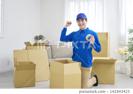 A moving company employee makes a triumphant gesture. A moving company employee makes a triumphant gesture. 142843425