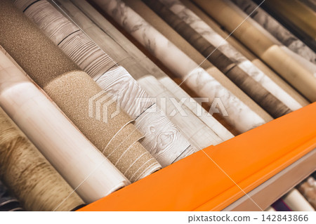 Assortment of light white wallpaper in rolls in a hardware store Assortment of light white wallpaper in rolls in a hardware store 142843866