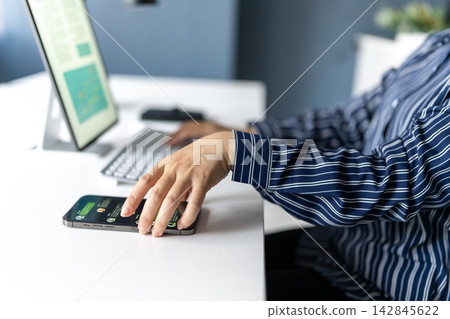 A woman holding a smartphone A woman holding a smartphone 142845622